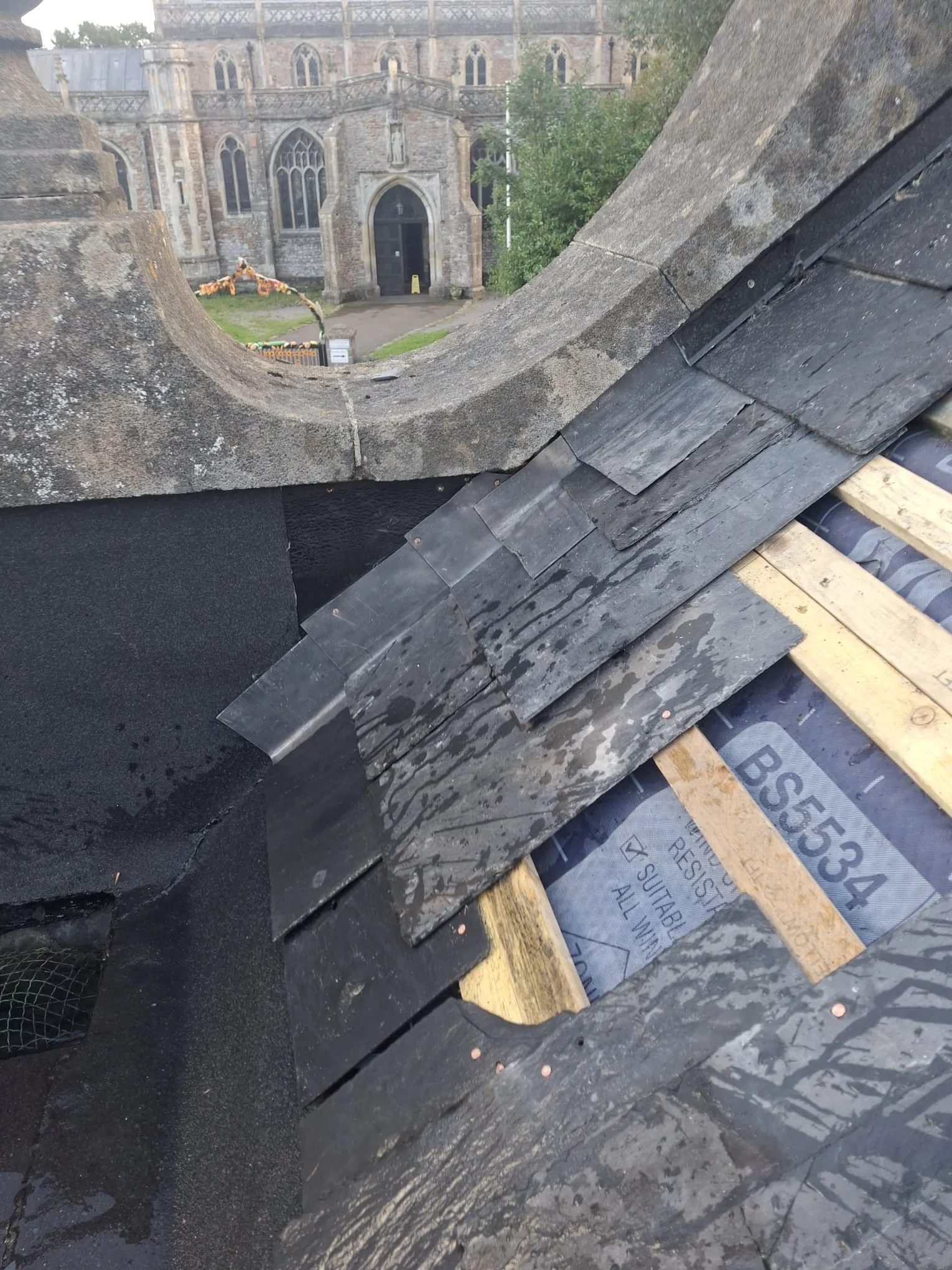 Slate work with underlay and battens exposed.